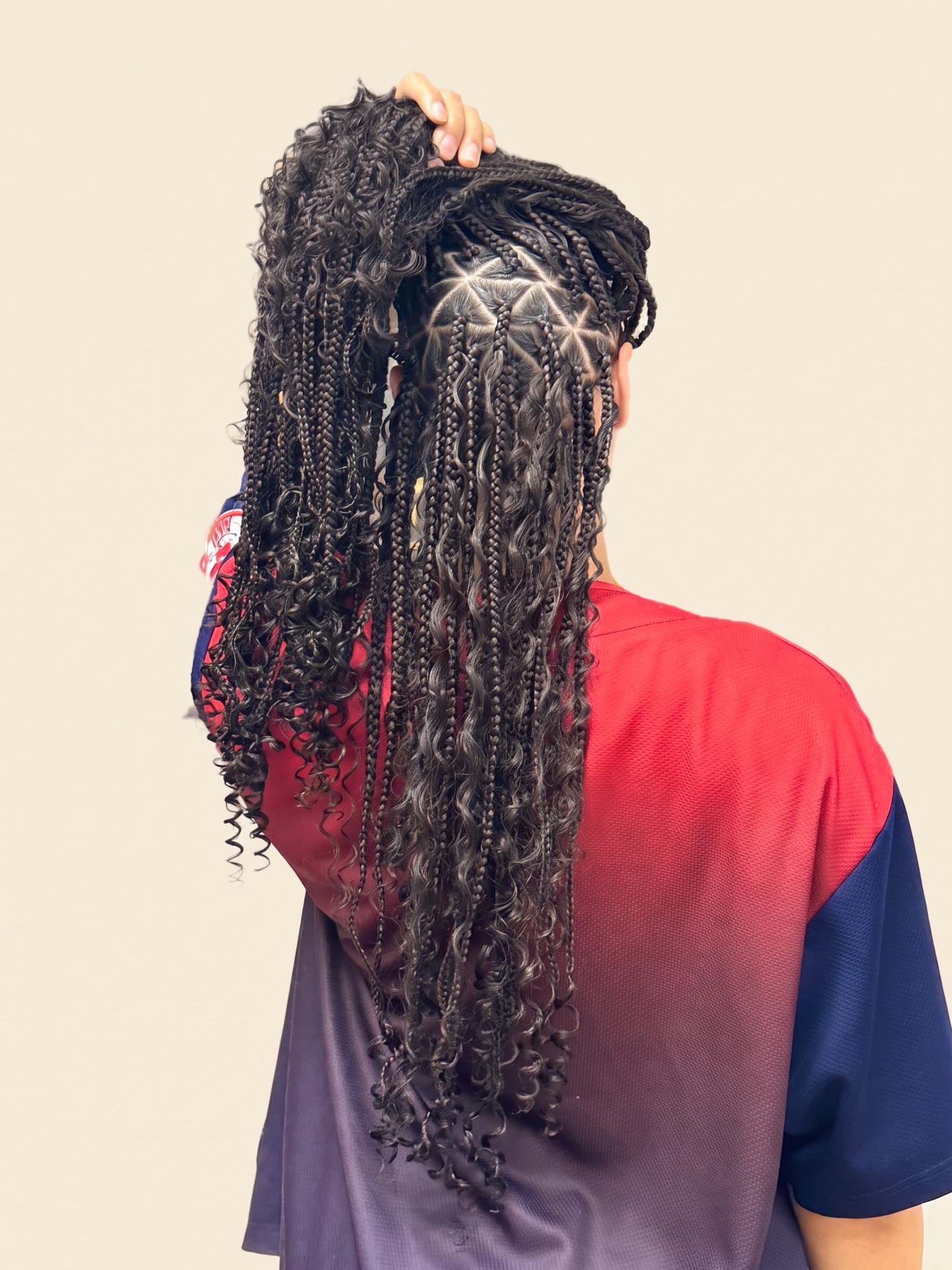 Back view of geometric triangle-parted boho braids with loose curls