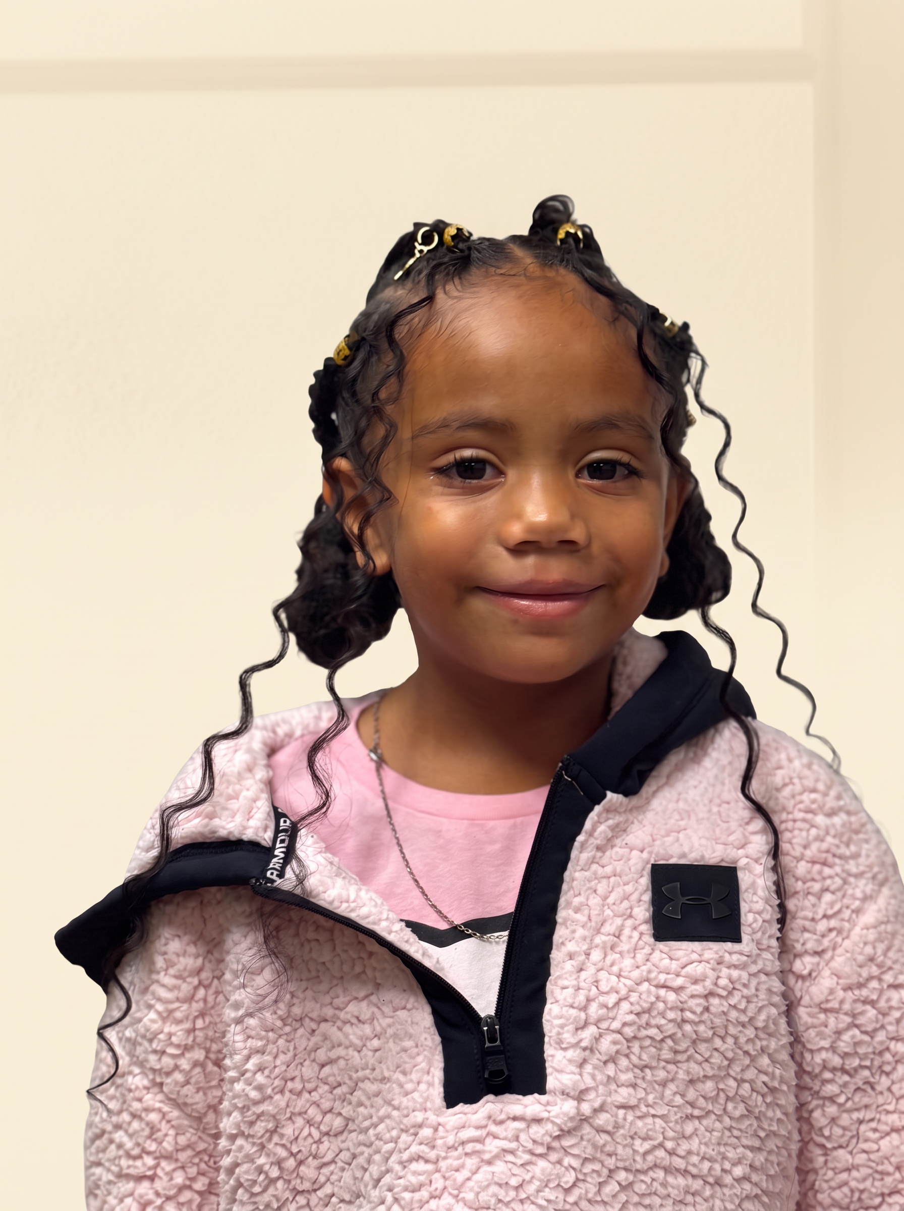 Child with a braided style and loose curls